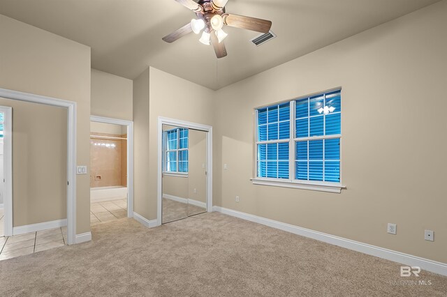 36 Lagoon Dr, Gulf Shores, AL 36542 - unfurnished bedroom featuring ensuite bathroom, carpet, visible vents, tile patterned floors, and baseboards