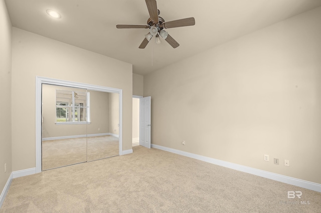 unfurnished bedroom with light carpet and ceiling fan