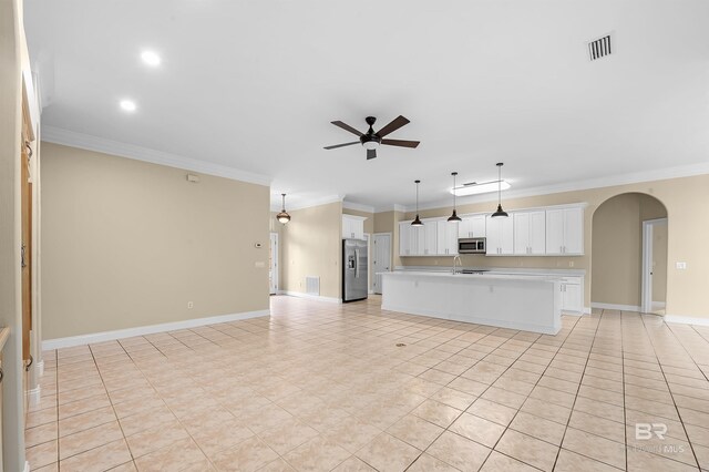 36 Lagoon Dr, Gulf Shores, AL 36542 - unfurnished living room featuring ornamental molding, visible vents, a ceiling fan, and arched walkways