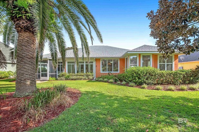 36 Lagoon Dr, Gulf Shores, AL 36542 - single story home featuring a front yard, stucco siding, and a shingled roof