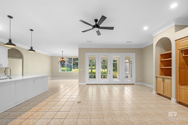 36 Lagoon Dr, Gulf Shores, AL 36542 - unfurnished living room with a sink, ornamental molding, baseboards, and light tile patterned floors