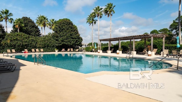 view of swimming pool featuring a patio area and a pergola