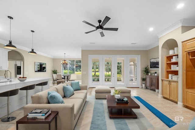 living room featuring ornamental molding, sink, light tile patterned floors, and ceiling fan