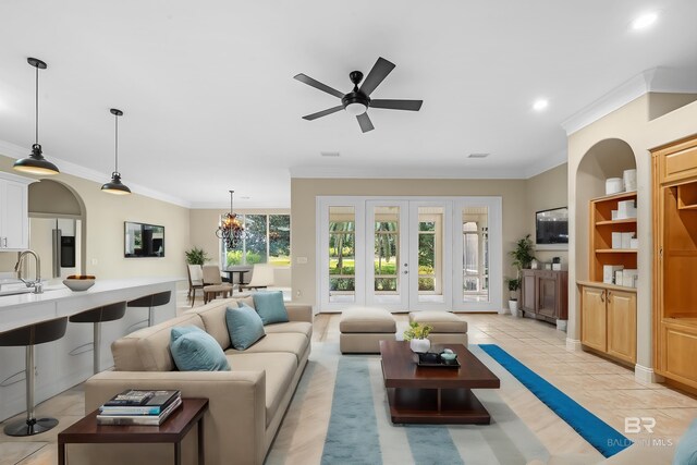 36 Lagoon Dr, Gulf Shores, AL 36542 - living room with light tile patterned floors, built in shelves, ornamental molding, a ceiling fan, and recessed lighting