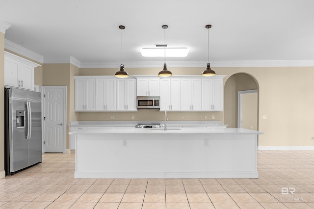 kitchen featuring a kitchen island with sink, ornamental molding, stainless steel appliances, and white cabinets