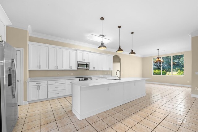 36 Lagoon Dr, Gulf Shores, AL 36542 - kitchen featuring ornamental molding, a chandelier, light tile patterned floors, light countertops, and stainless steel appliances