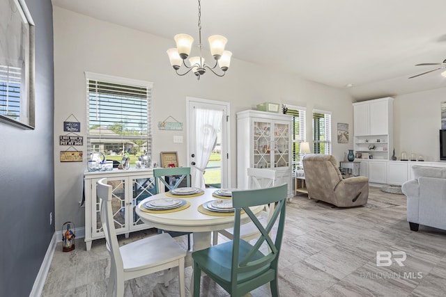 dining area with ceiling fan with notable chandelier