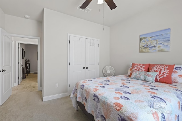 bedroom featuring ceiling fan, a closet, and light carpet