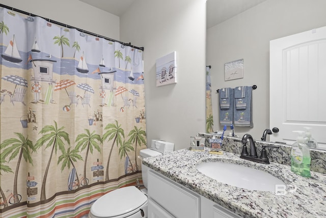 bathroom featuring a shower with curtain, vanity, and toilet