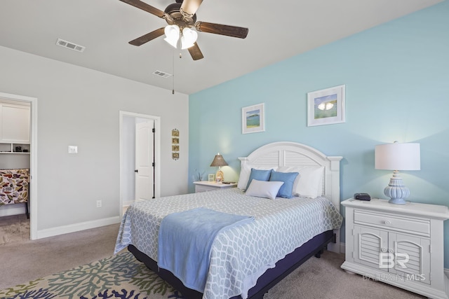 bedroom with ceiling fan, light colored carpet, a spacious closet, and a closet