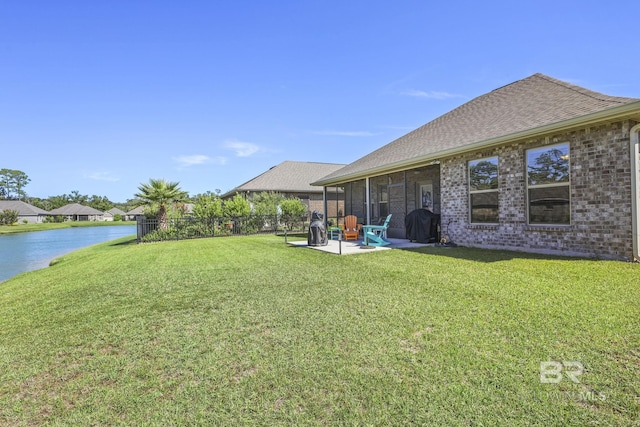 view of yard with a patio area and a water view