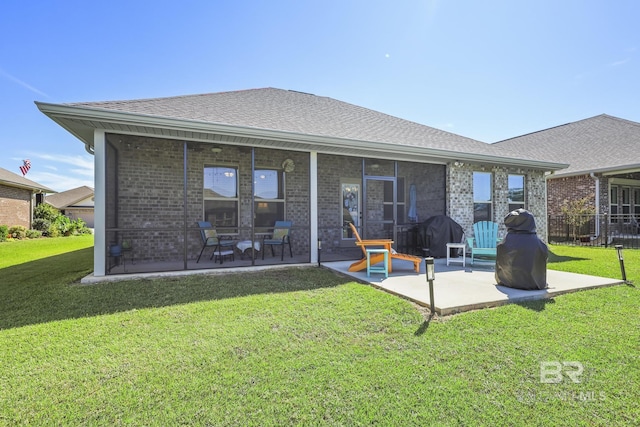 back of property featuring a lawn and a patio