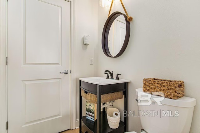 bathroom featuring vanity and toilet