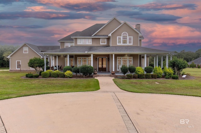 view of front of home with a lawn and covered porch