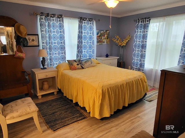 2200 W 2nd St Unit B-106, Gulf Shores, AL 36542 - bedroom featuring light wood-style floors and crown molding