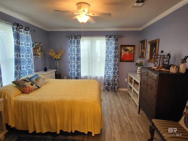 2200 W 2nd St Unit B-106, Gulf Shores, AL 36542 - bedroom featuring wood finished floors, ornamental molding, a ceiling fan, and baseboards