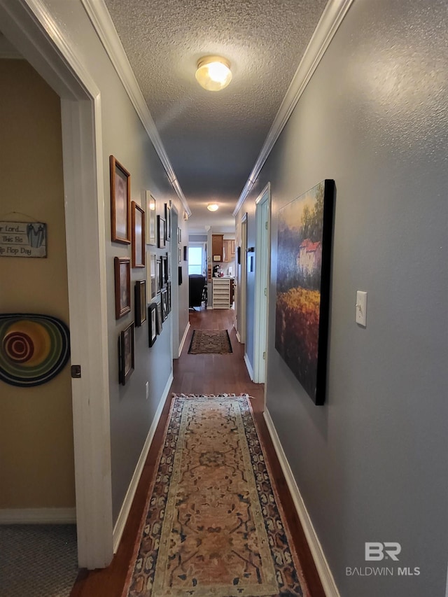 2200 W 2nd St Unit B-106, Gulf Shores, AL 36542 - hallway with ornamental molding, dark wood-style floors, a textured ceiling, and baseboards