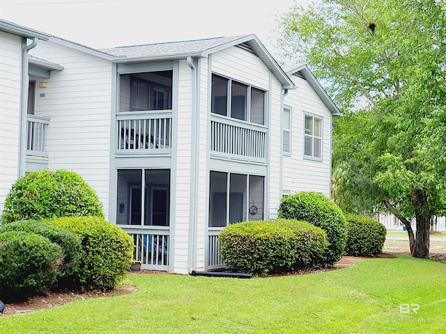 2200 W 2nd St Unit B-106, Gulf Shores, AL 36542 - view of side of property featuring a lawn
