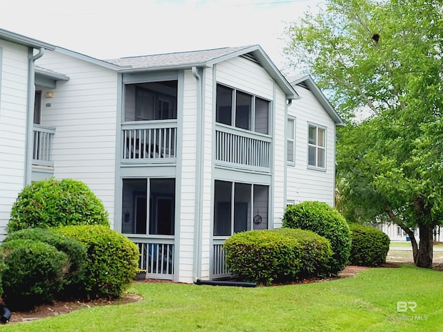 2200 W 2nd St Unit B-106, Gulf Shores, AL 36542 - view of property exterior featuring a yard