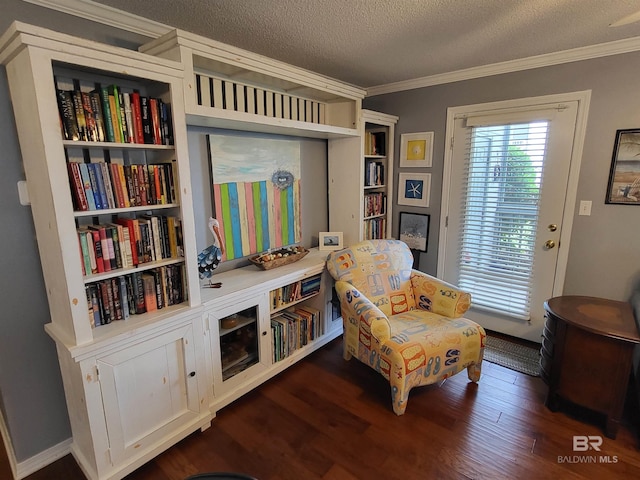 2200 W 2nd St Unit B-106, Gulf Shores, AL 36542 - sitting room featuring ornamental molding, dark wood-style flooring, and a textured ceiling