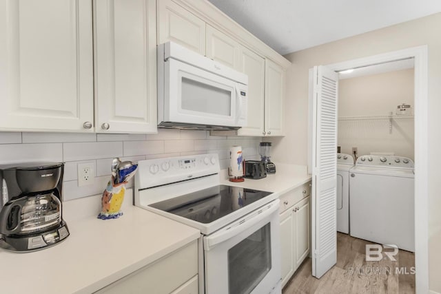 kitchen featuring white cabinets, tasteful backsplash, light wood-style floors, white appliances, and light countertops