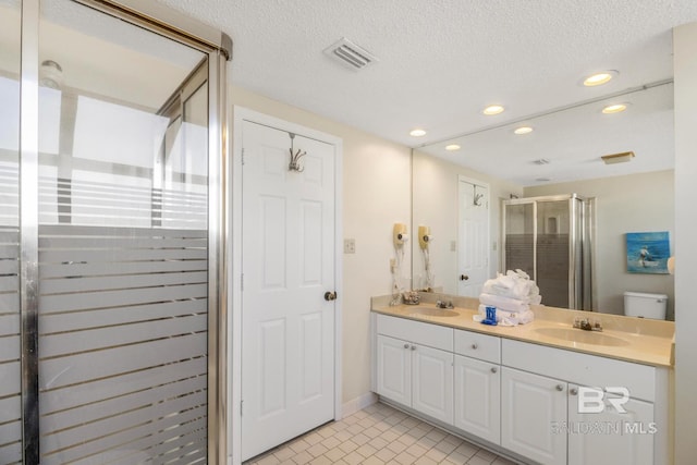 bathroom featuring visible vents, a shower stall, a sink, and recessed lighting