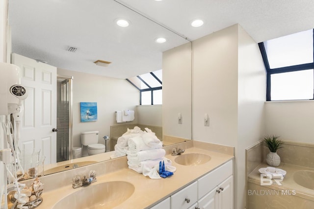 bathroom with a bath, double vanity, toilet, and a sink