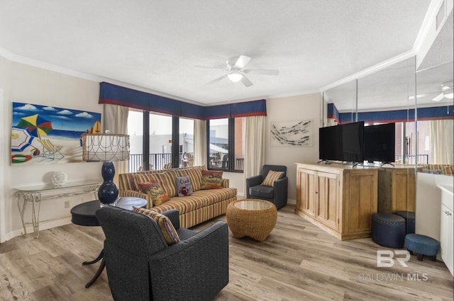 living area featuring a healthy amount of sunlight, ceiling fan, and crown molding