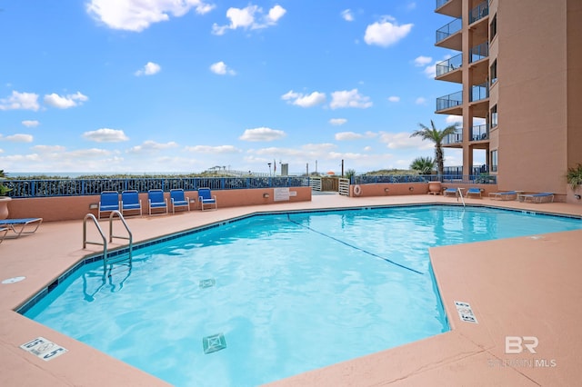 pool featuring a patio area and fence