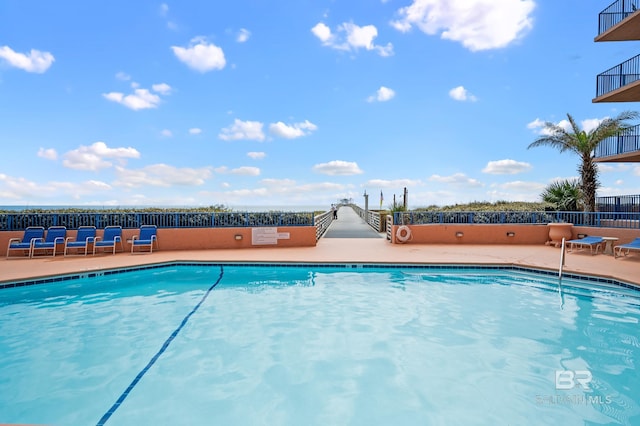 pool featuring a patio area and fence