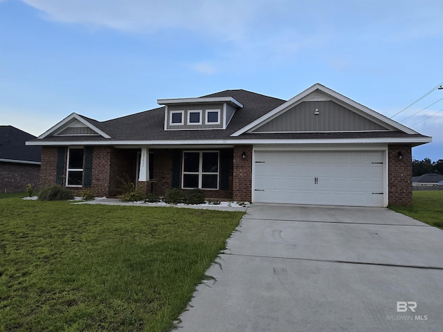 23035 Ridgewood Dr, Robertsdale, AL 36567 - view of front of home with brick siding, a front lawn, driveway, and an attached garage