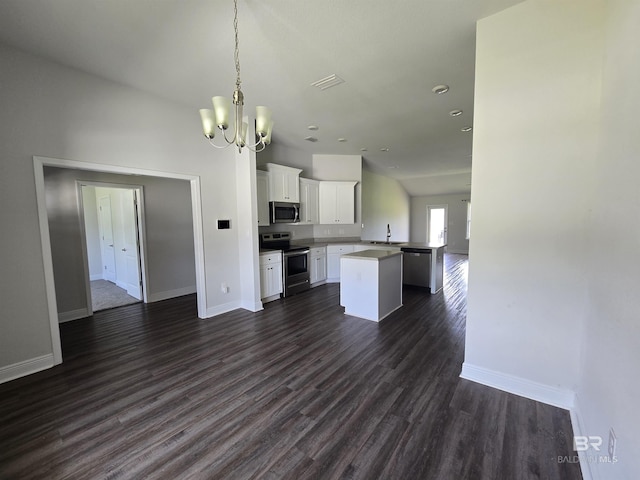 23035 Ridgewood Dr, Robertsdale, AL 36567 - kitchen featuring appliances with stainless steel finishes, open floor plan, a chandelier, dark wood-style floors, and white cabinets