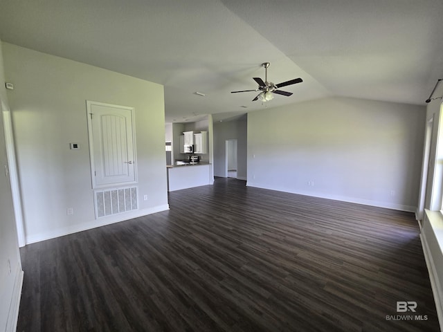 23035 Ridgewood Dr, Robertsdale, AL 36567 - unfurnished living room with dark wood-style floors, ceiling fan, and vaulted ceiling