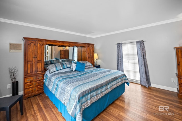 bedroom featuring crown molding, baseboards, and wood finished floors