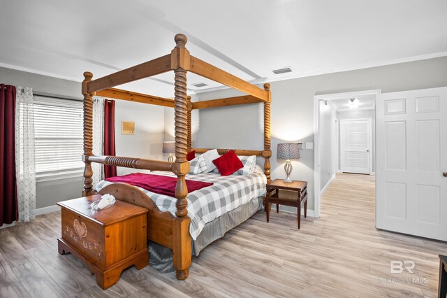 bedroom featuring baseboards, light wood-style floors, and crown molding