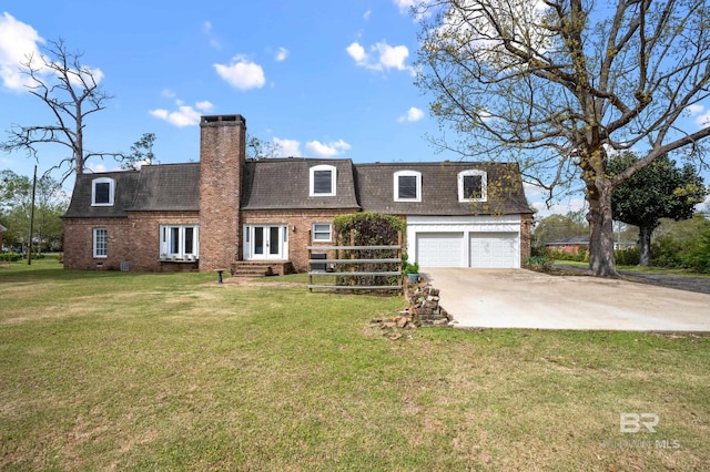 view of front of property featuring a shingled roof, brick siding, a front yard, concrete driveway, and mansard roof