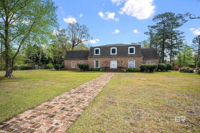 803 S Pensacola Ave, Atmore, AL 36502 - view of front of property featuring brick siding, a shingled roof, a front lawn, and mansard roof