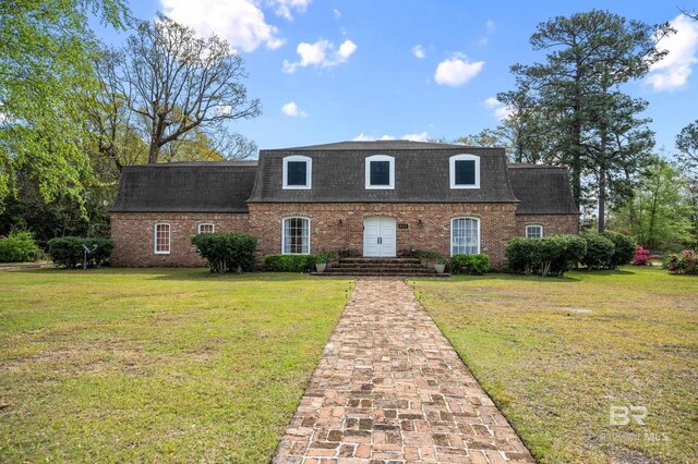803 S Pensacola Ave, Atmore, AL 36502 - view of front of home with a shingled roof, brick siding, a front yard, and mansard roof