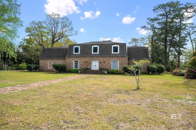 803 S Pensacola Ave, Atmore, AL 36502 - view of front of property with mansard roof, a shingled roof, brick siding, and a front yard
