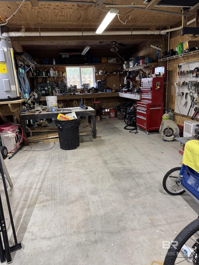 garage featuring a workshop area and electric water heater