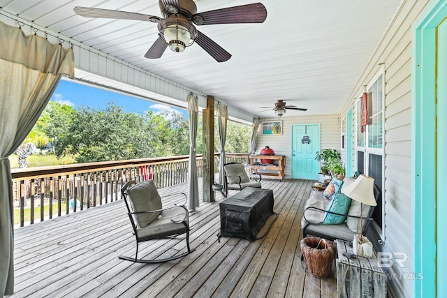 wooden terrace featuring ceiling fan