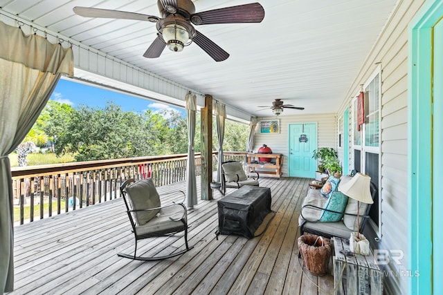 wooden deck featuring ceiling fan