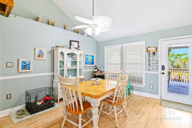 dining area with vaulted ceiling, a wealth of natural light, ceiling fan, and light wood-type flooring