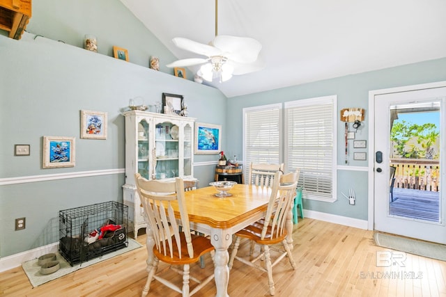 dining room with vaulted ceiling, light wood finished floors, baseboards, and a healthy amount of sunlight