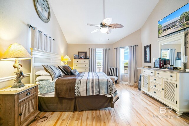 bedroom with ceiling fan, high vaulted ceiling, baseboards, and light wood-style floors