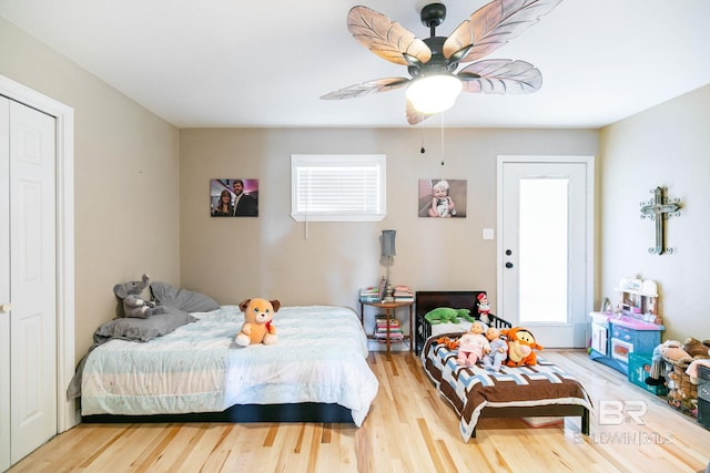 bedroom with multiple windows, a ceiling fan, and wood finished floors