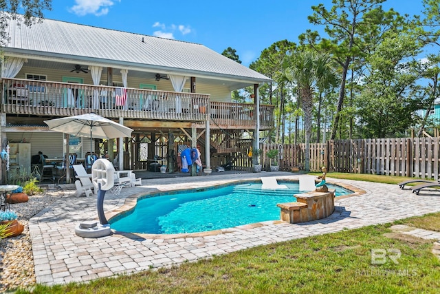 view of swimming pool featuring a fenced in pool, a hot tub, ceiling fan, fence, and a wooden deck