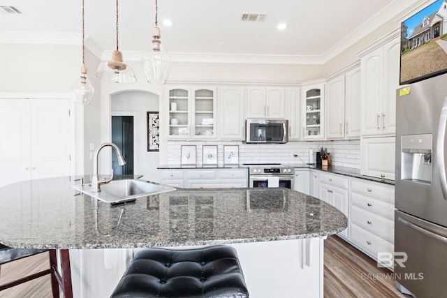 kitchen featuring hanging light fixtures, sink, decorative backsplash, appliances with stainless steel finishes, and white cabinetry