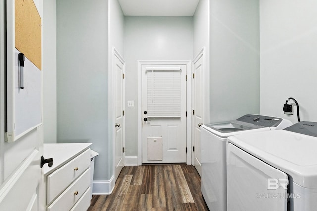 laundry room featuring washing machine and clothes dryer and dark hardwood / wood-style flooring