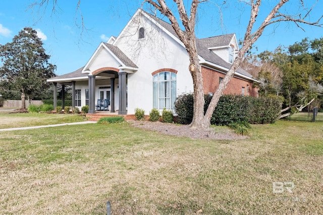 view of front of home with a porch and a front lawn